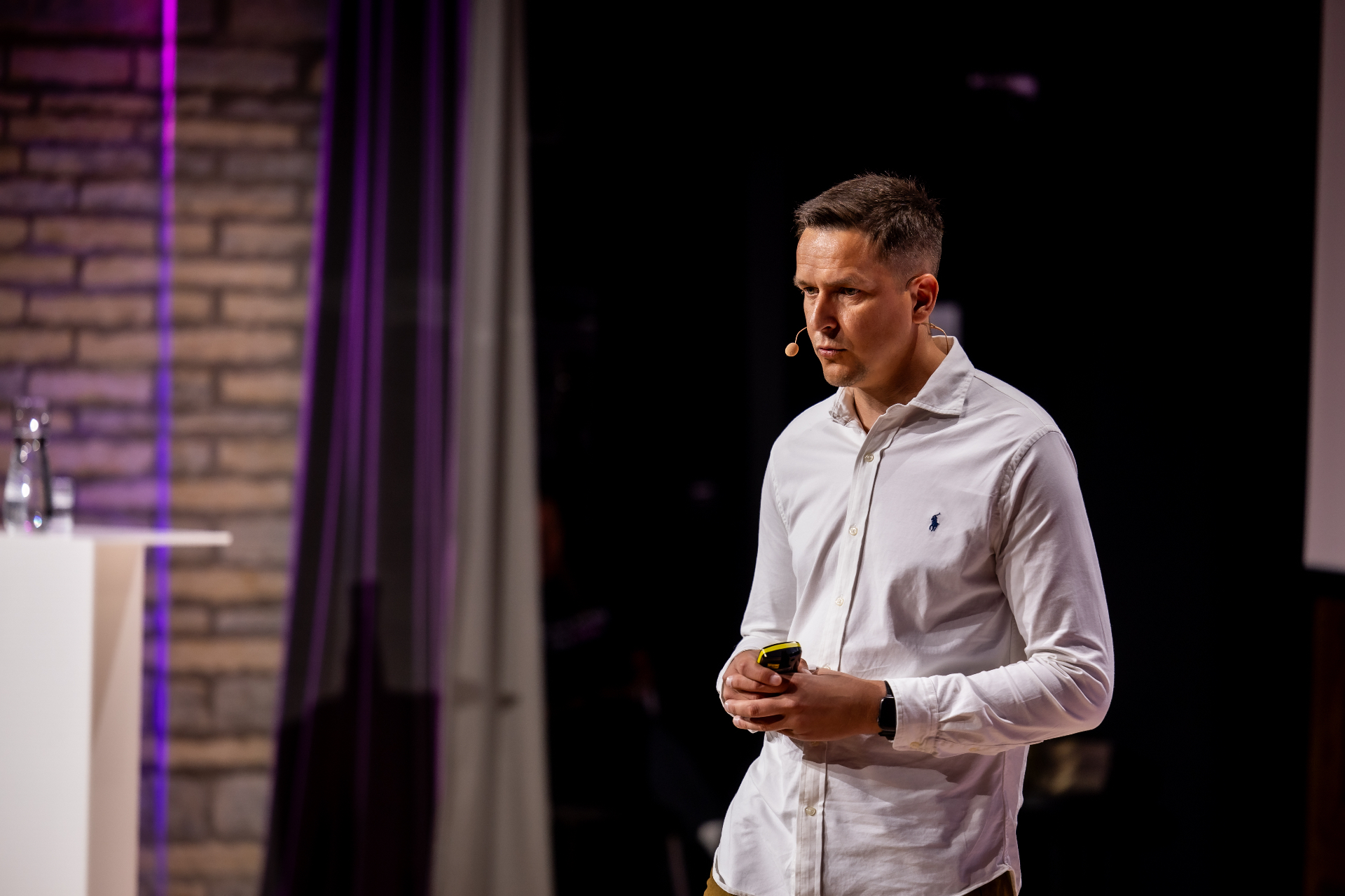 Side view photo of Indrek Reimand delivering his keynote at Service Design Day 2026.